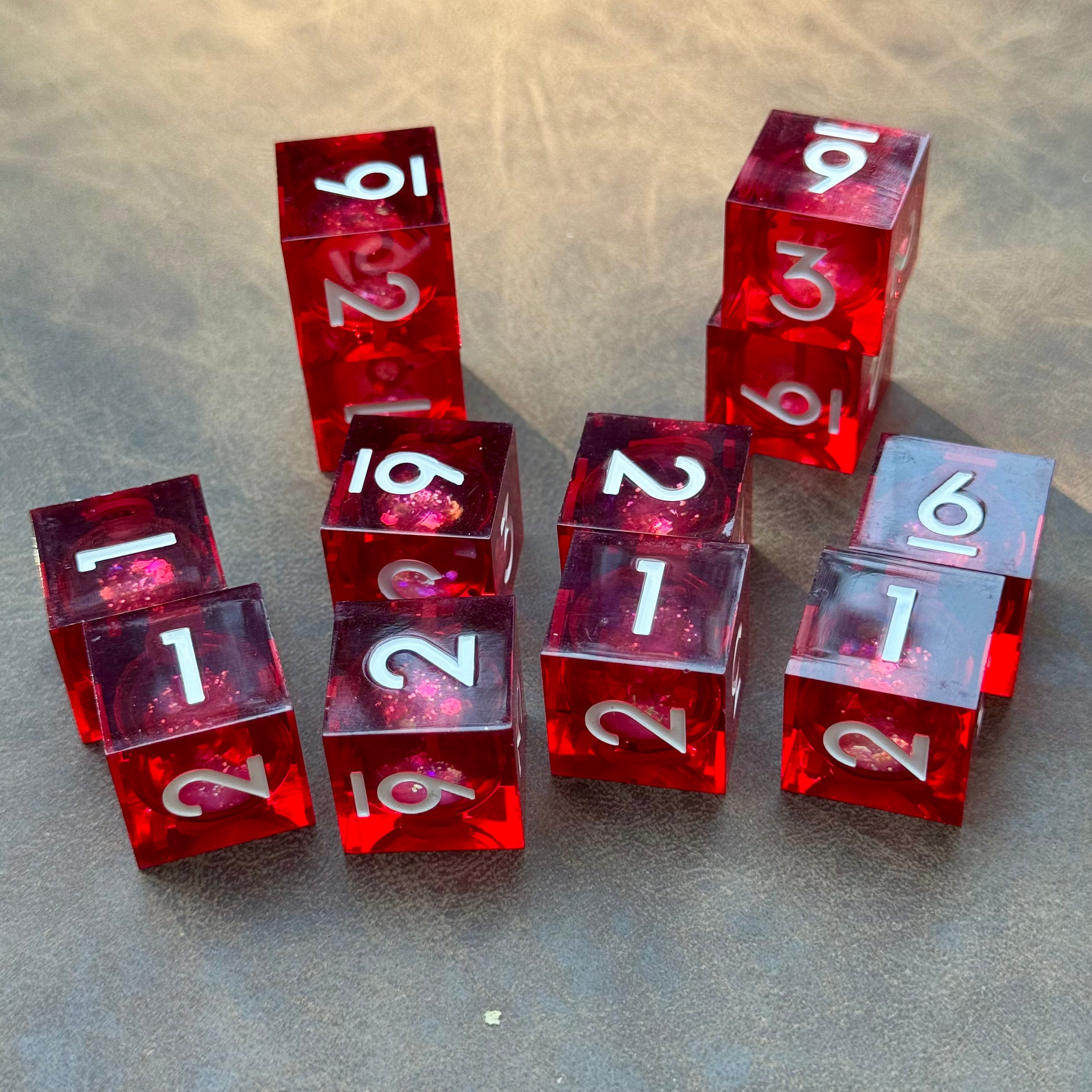 Crimson Current set of twelve red liquid-core D6 dice with silver-white numbers