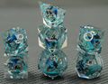 Glacier Wyrm clear liquid core RPG dice with blue dragon artwork, aqua shimmer and silver numbers