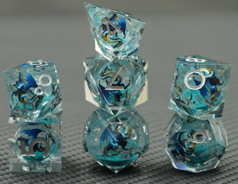 Glacier Wyrm clear liquid core RPG dice with blue dragon artwork, aqua shimmer and silver numbers